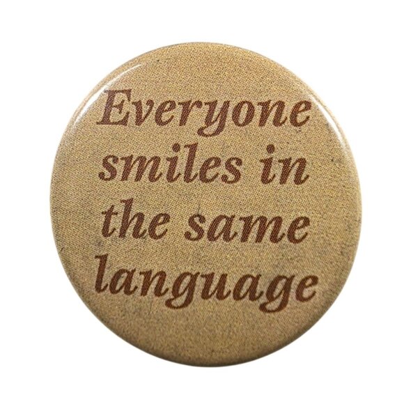 Everyone Smiles In The Same Language Pinback Button 1.5" Vintage Style Metal - Picture 1 of 3